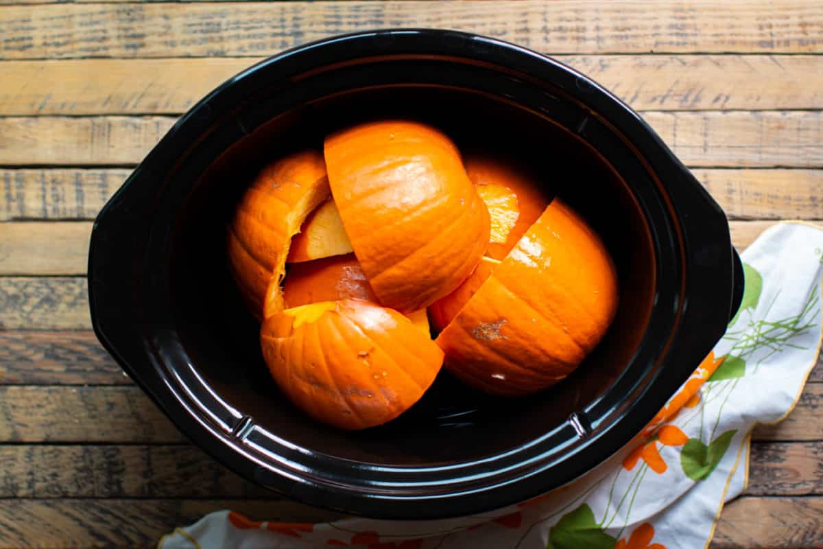 pumpkin pieces in the slow cooker.