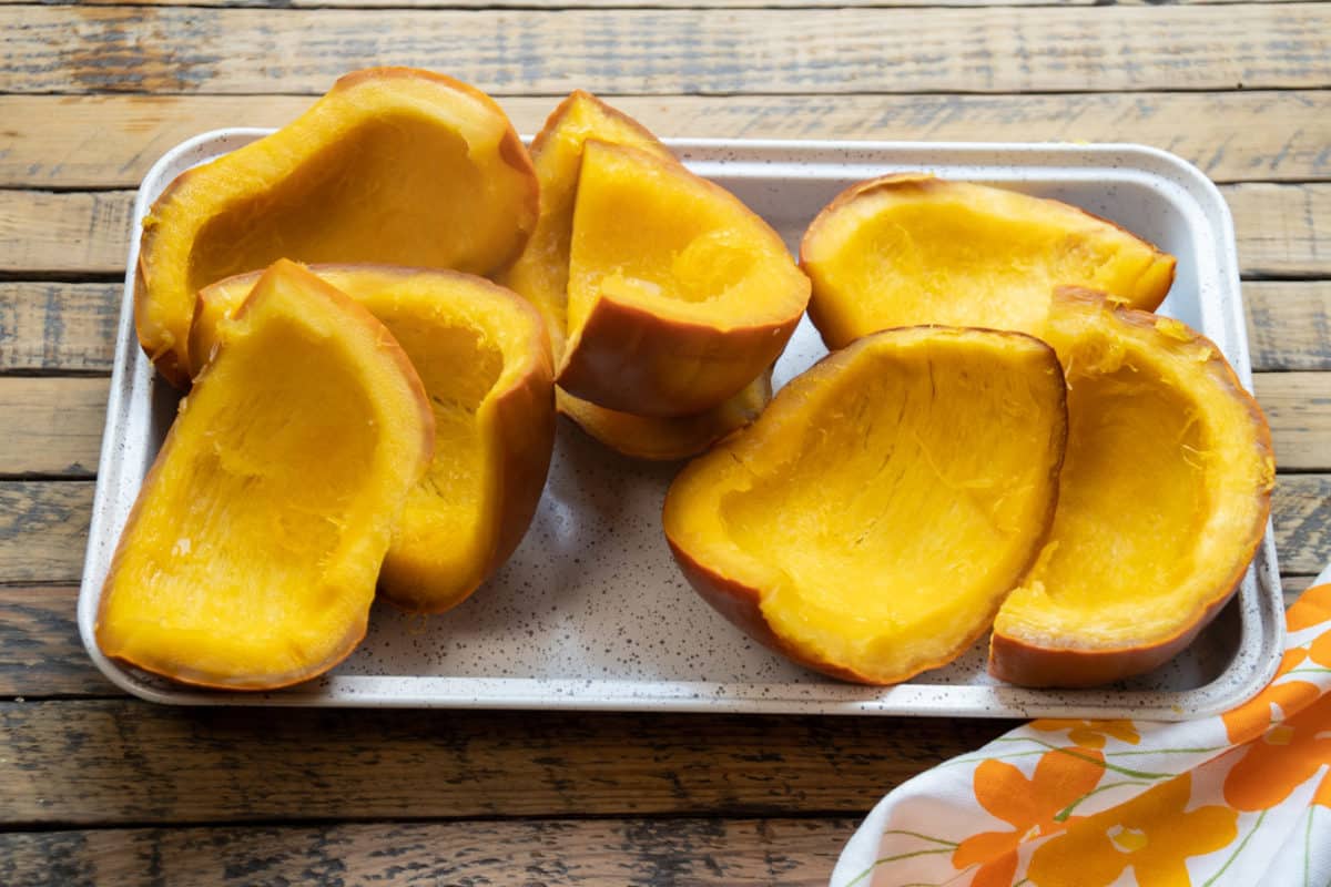 cooked pumpkin pieces on a small sheet pan.