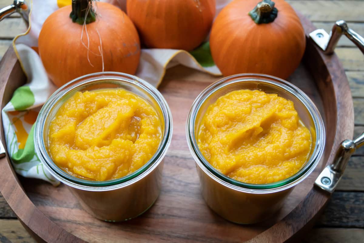 close up of 2 jars of pumpkin puree.