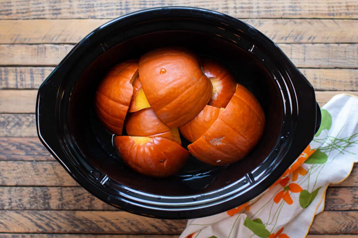cooked pumpkin pieces in the slow cooker.
