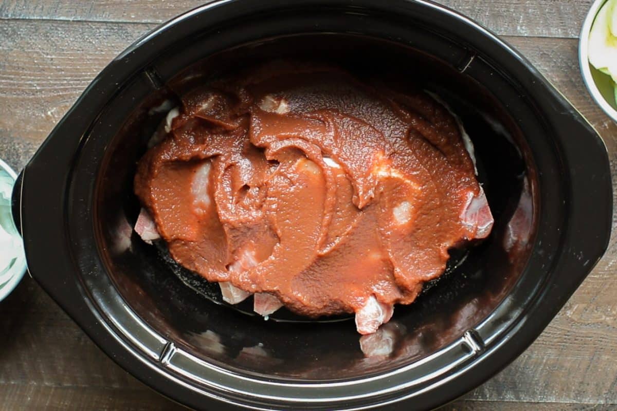 pork chops in the slow cooker with apple butter spread over the top.