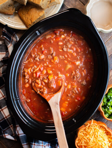 pumpkin chili with meat and beans. Cornbread, cheese and onions on the side.