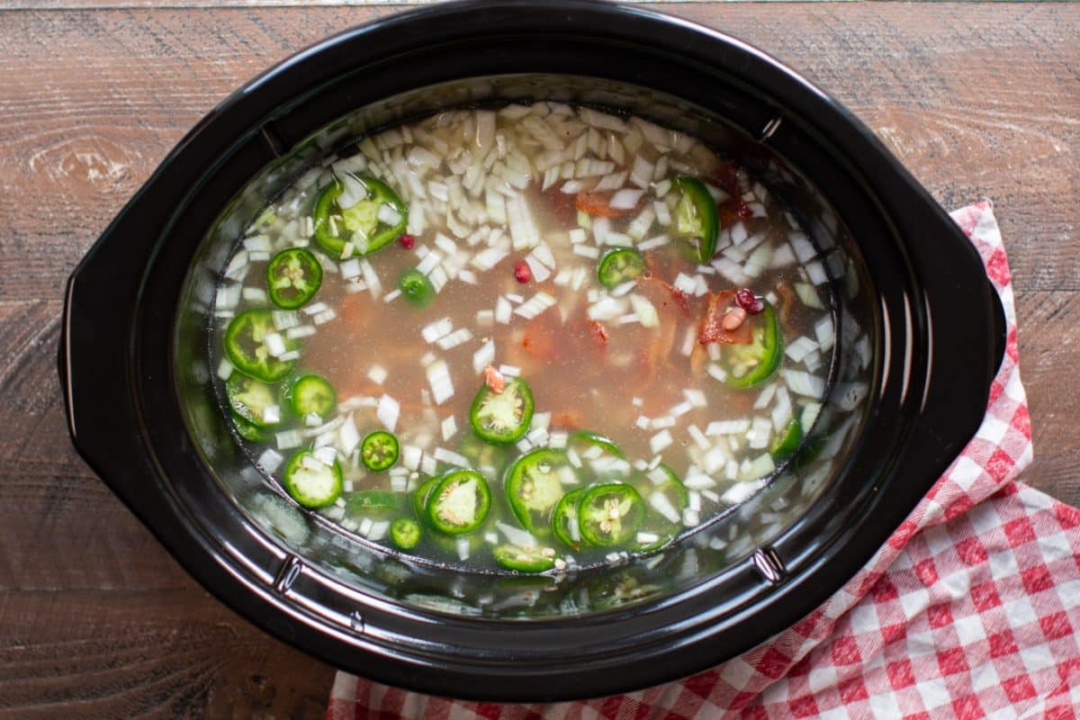 water onion, jalapenos, beans in slow cooker uncooked.