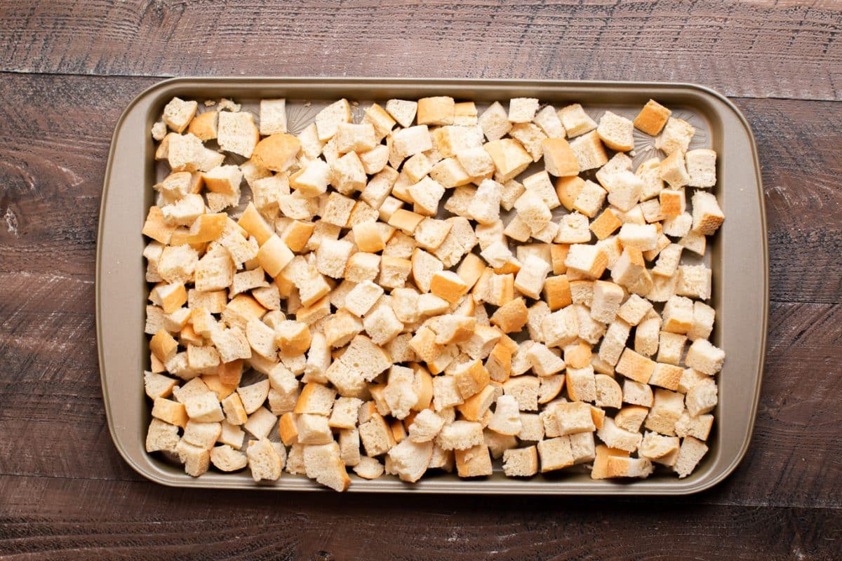 a sheet pan with cubes of bread