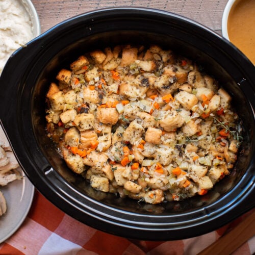 cooked stuffing in an oval slow cooker