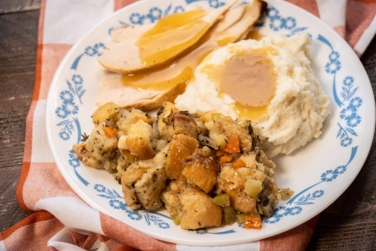 a plage with stuffing, turkey, mashed potatoes and gravy