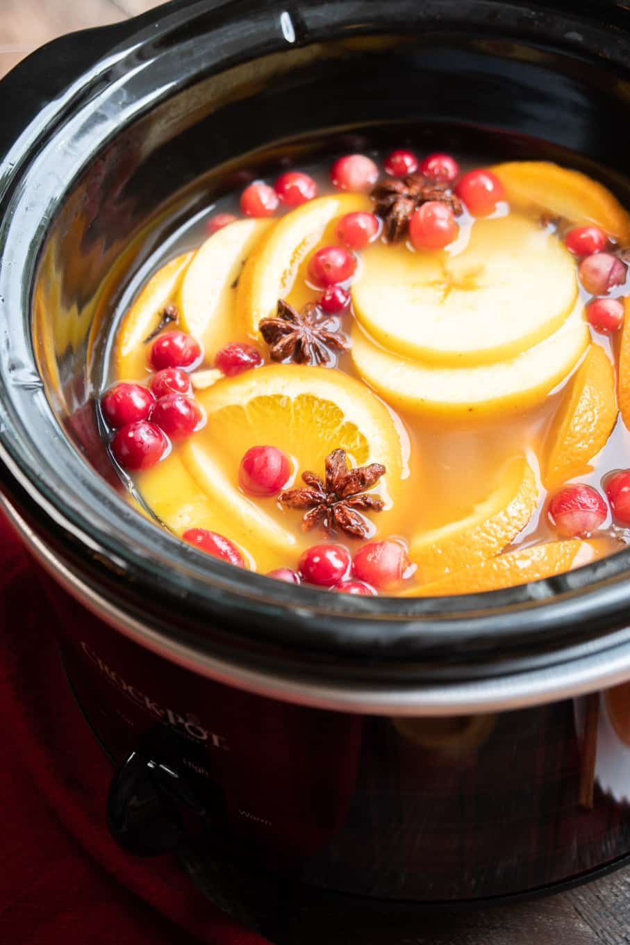 close up of apple cider in round slow cooker.