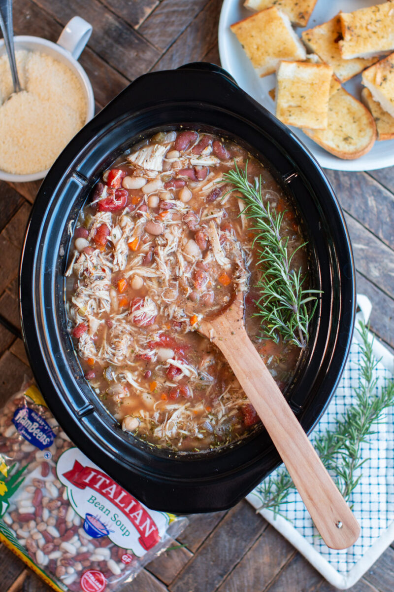 Multi bean soup in the slow cooker. Sprigs of rosemary on top.