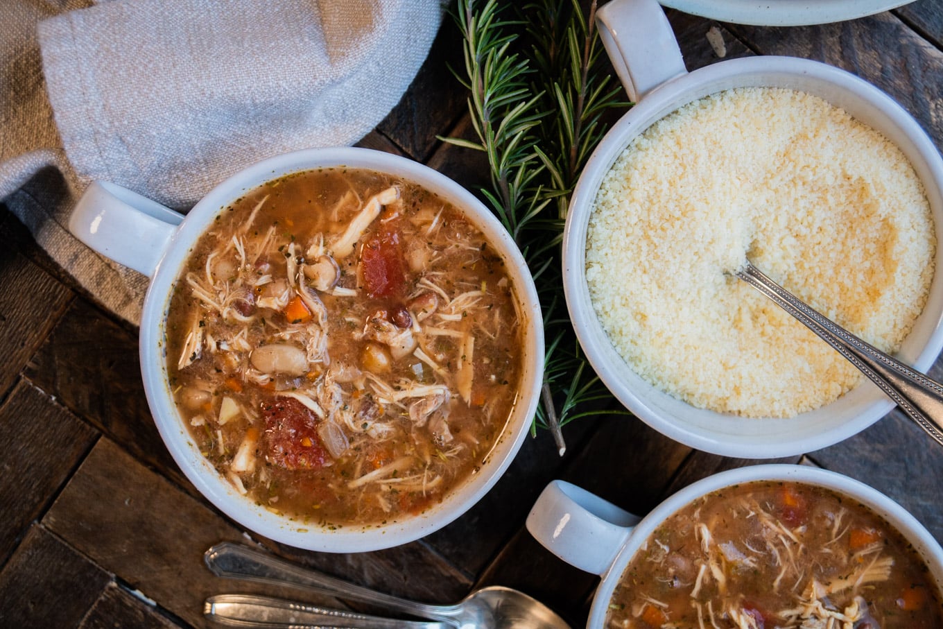 2 bowls of bean soup, 1 bowl of parmesan cheese.