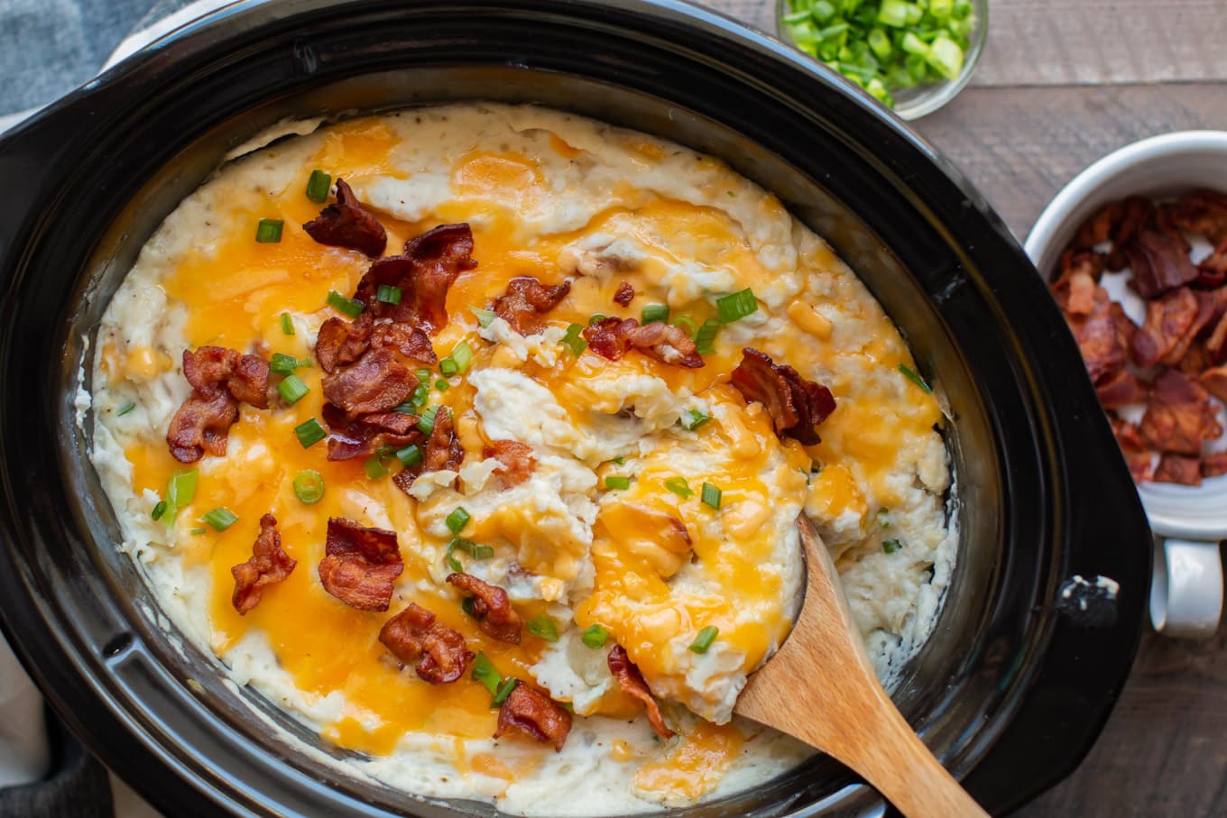 baked potato casserole with wooden spoon in it.