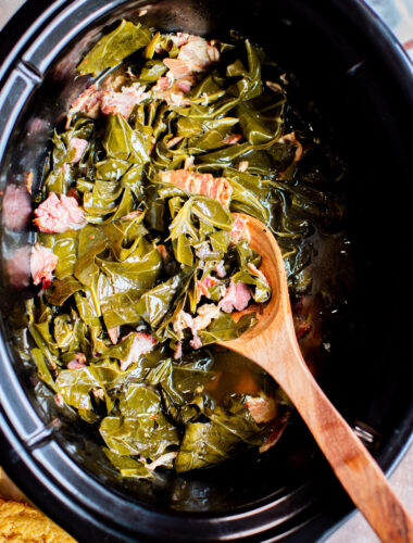 close up of collard greens with ham hocks.