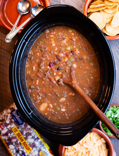 slow cooker full of taco 15 bean soup. Wooden spoon in it.