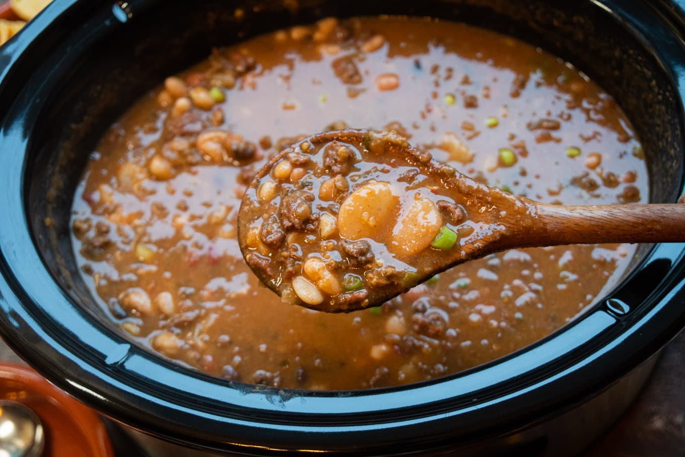 taco 15 bean soup in slow cooker with spoon scooping it out