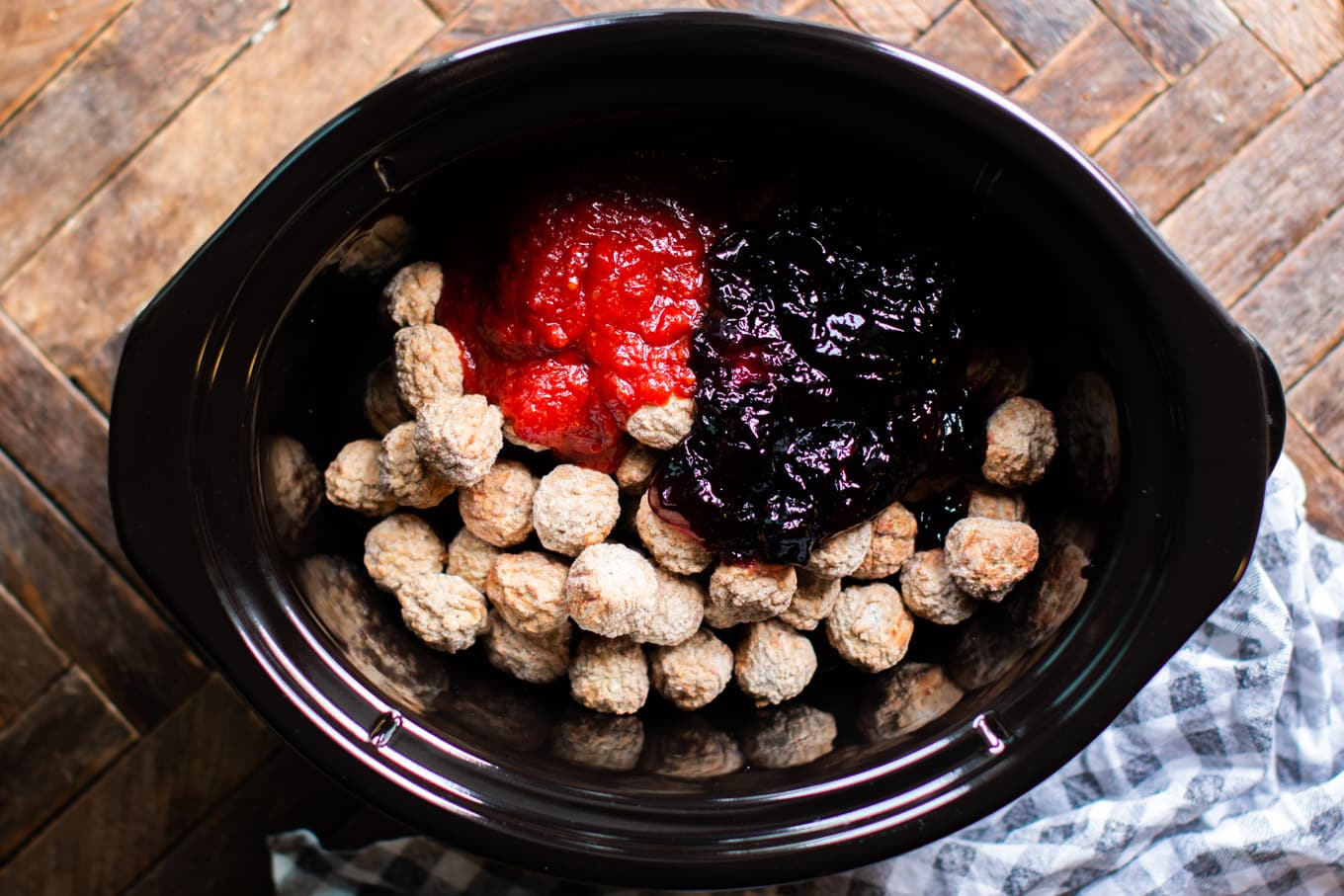 meatballs, grape jelly, heinz chili sauce in crockpot before cooking.