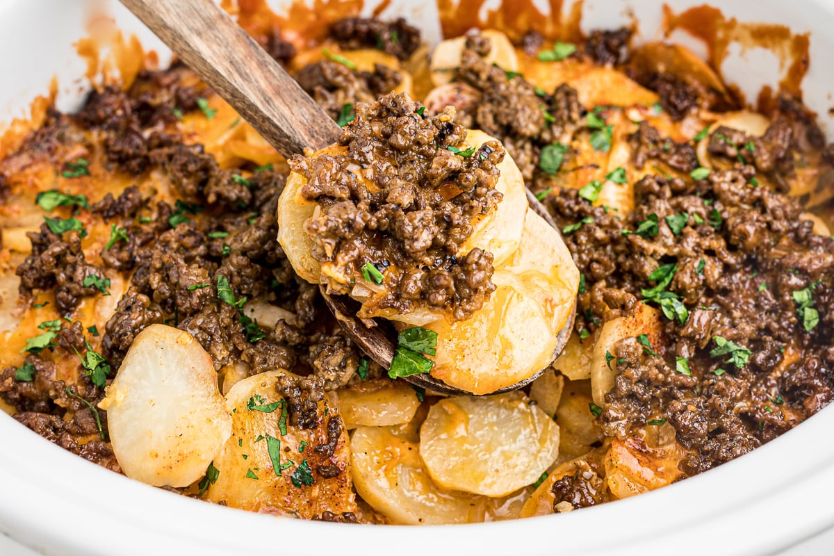 close up of beef and potatoes on a spatula.