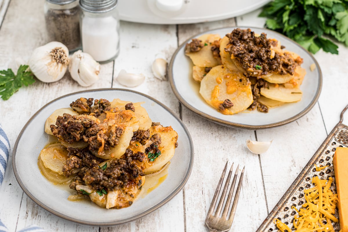 Plates of beef gratin with fork.