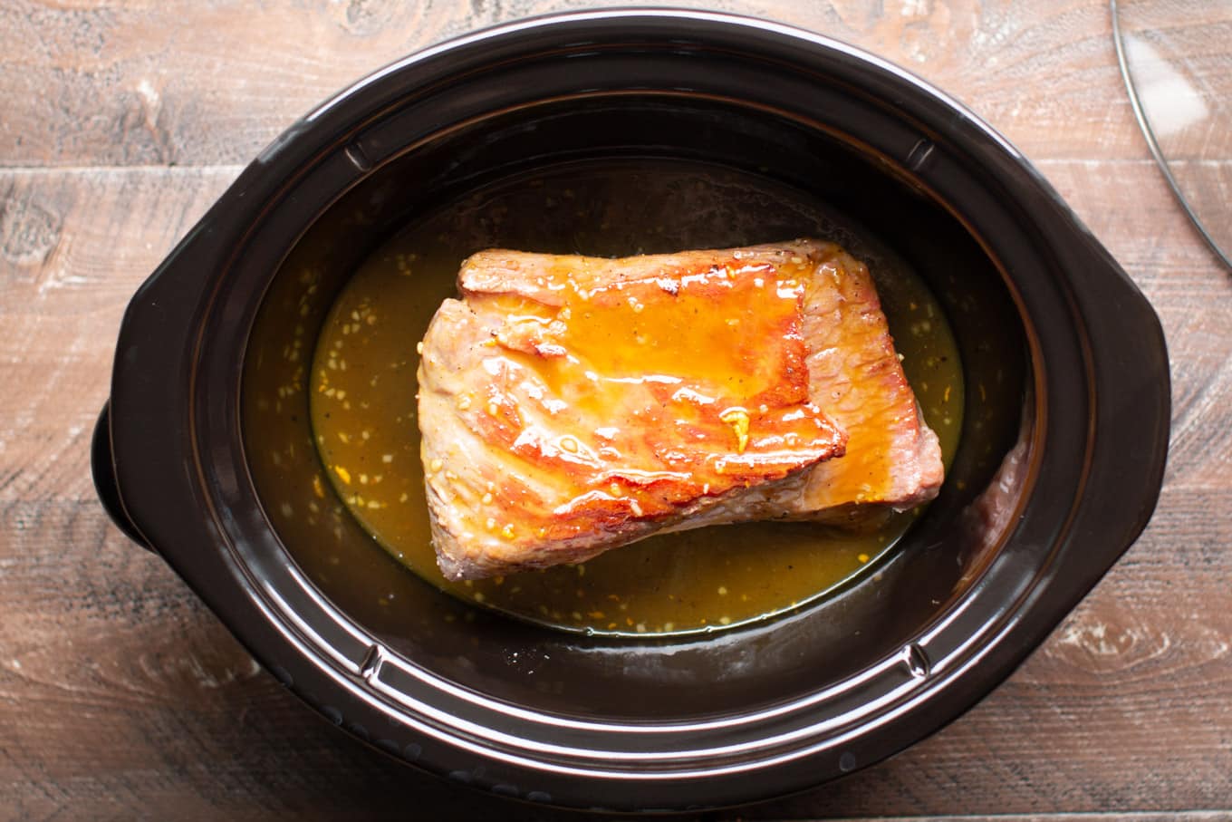 raw corned beef with maple mustard in crockpot