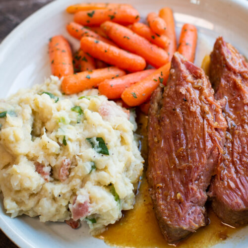 plated maple mustard corned beef with colcannon potatoes and carrots