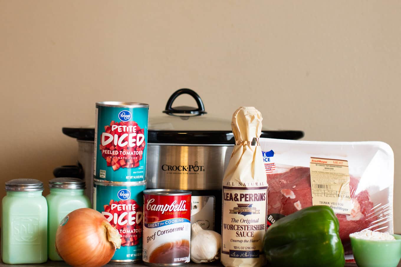 ingredients for swiss steak in front of crockpot