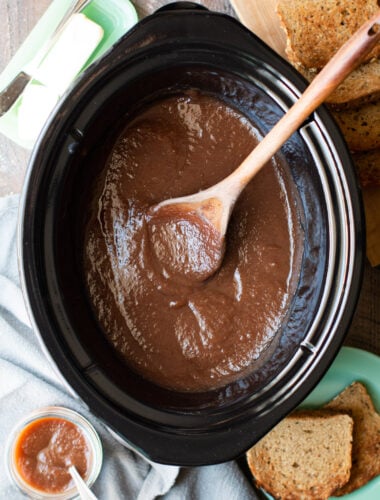 slow cooker half full of cooked apple butter