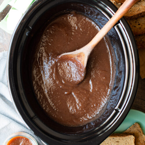 slow cooker half full of cooked apple butter