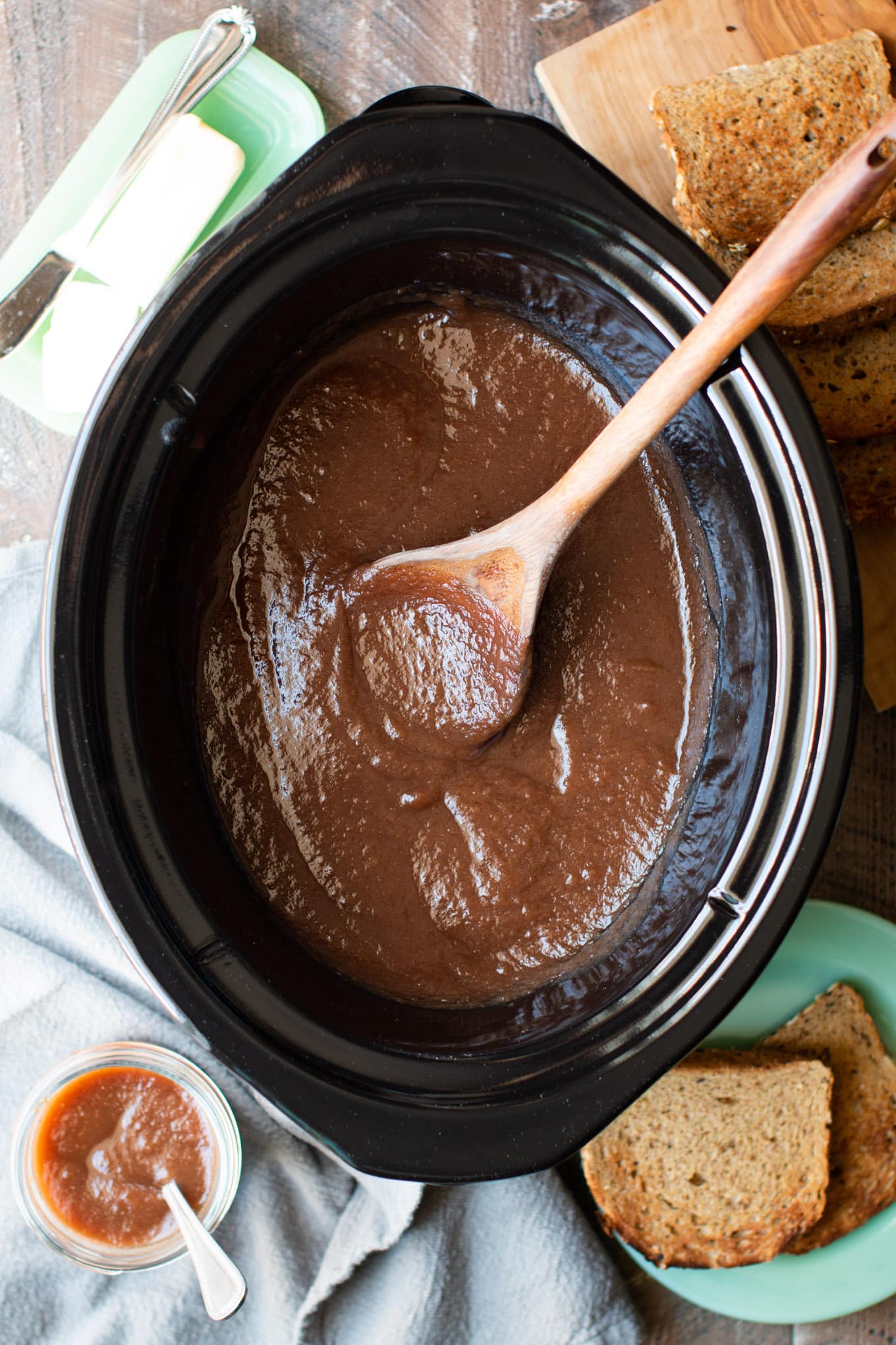 slow cooker half full of cooked apple butter