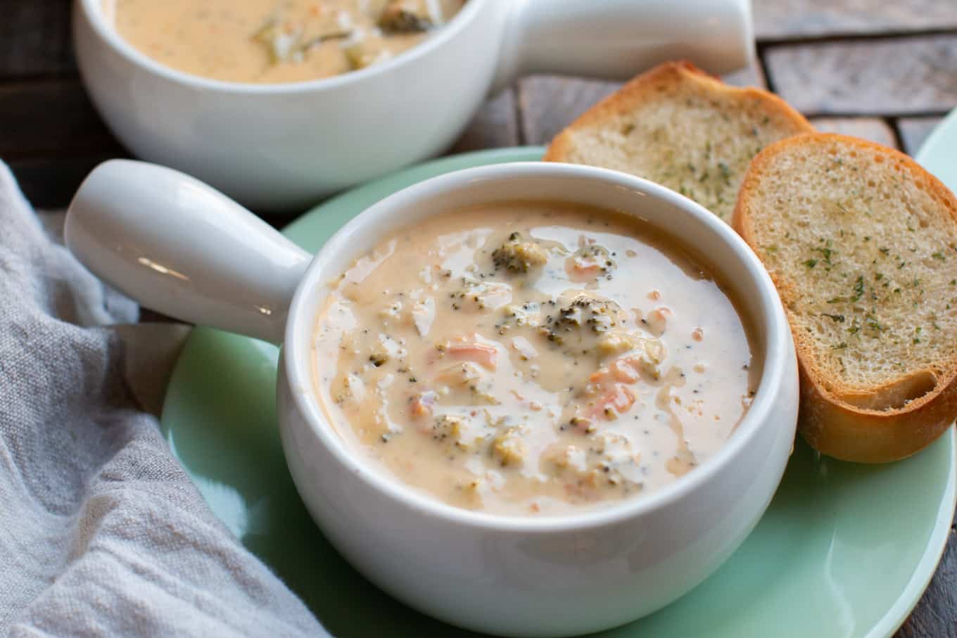 broccoli cheese soup with garlic bread on side