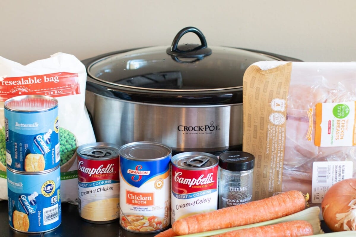 Ingredients for chicken and dumplings; chicken, cream soups, chicken broth, carrots, onion, celery, thyme and biscuits.