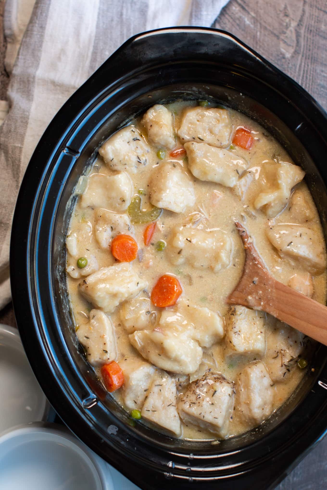 close up of chicken and dumplings in slow cooker.