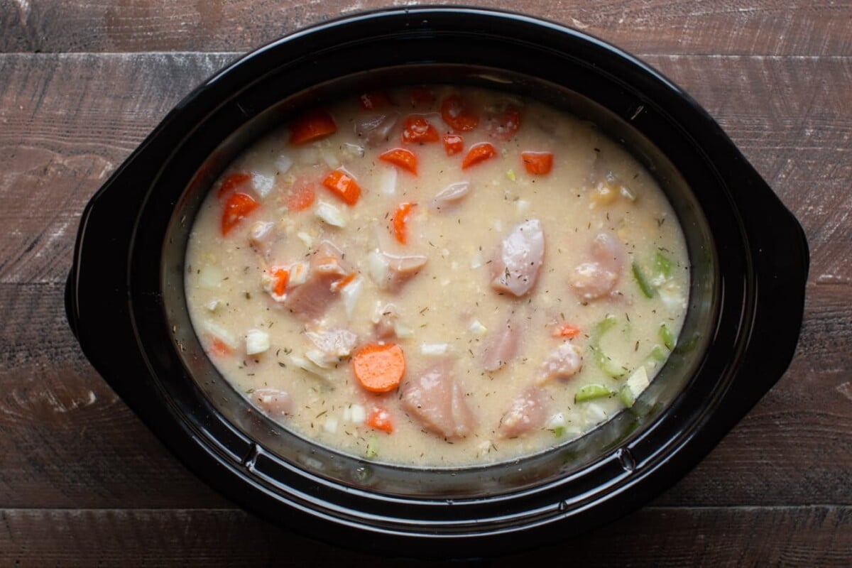 uncooked chicken, cream soups and veggies in slow cooker
