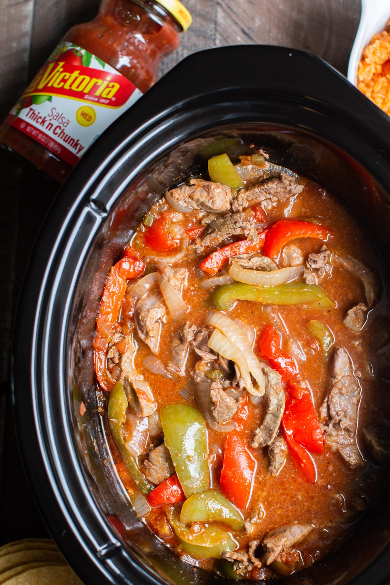 beef strips in sauce with veggies in slow cooker.