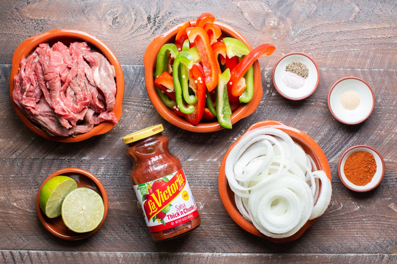 beef strips, salsa, onion, bell peppers, chili powder, garlic powder, salt and pepper and lime