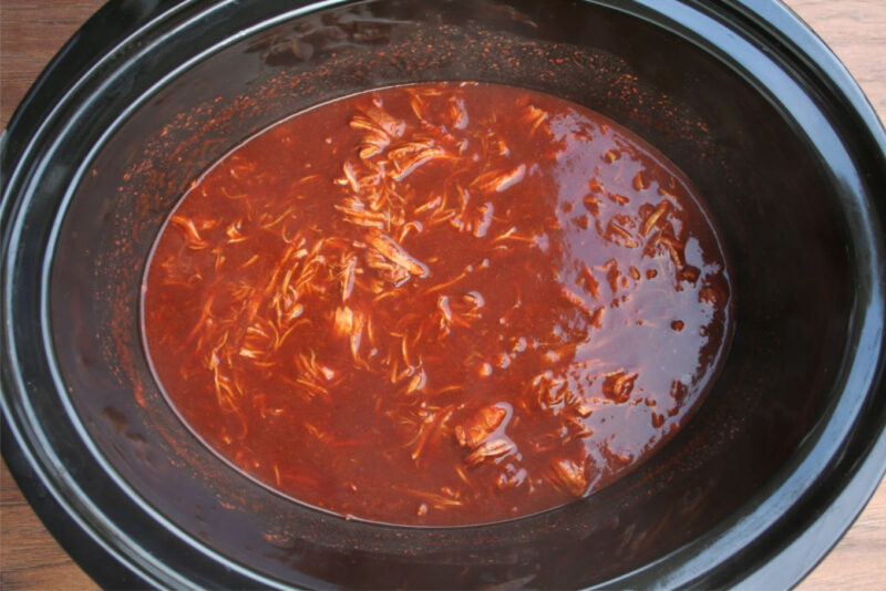 chicken and enchilada sauce cooked in slow cooker