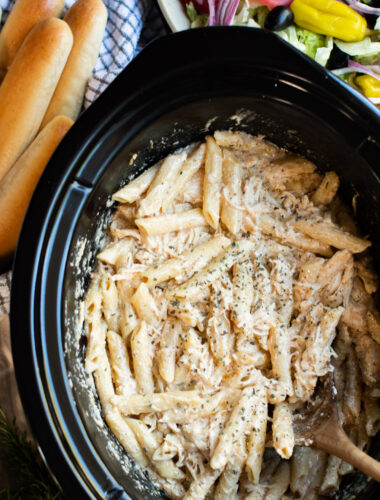 close up of pasta, chicken and cheese in slow cooker