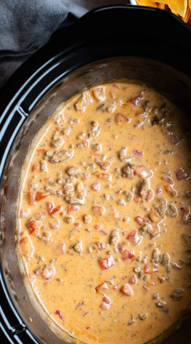 close up of rotel and velveeta dip in slow cooker