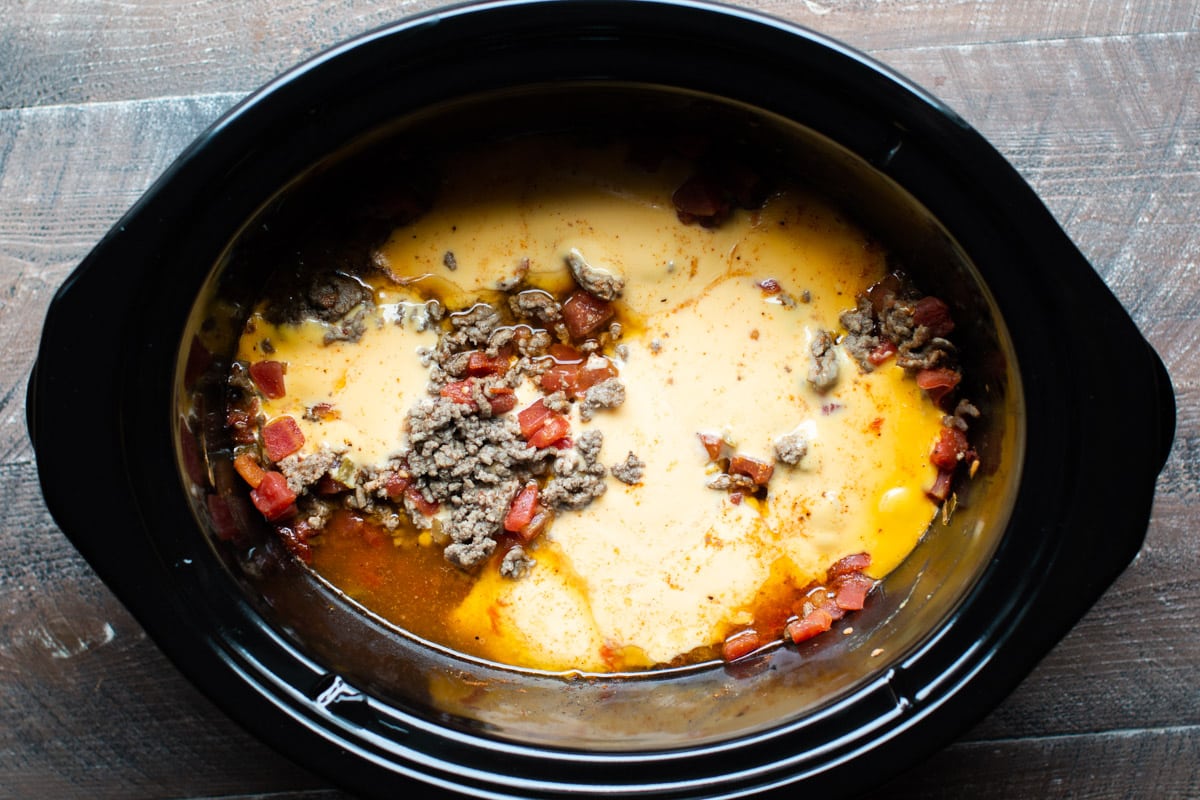 melted velveeta in slow cooker with ground beef and rotel