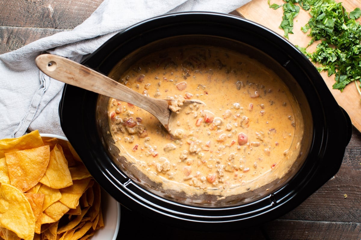 spoon in rotel dip in slow cooker