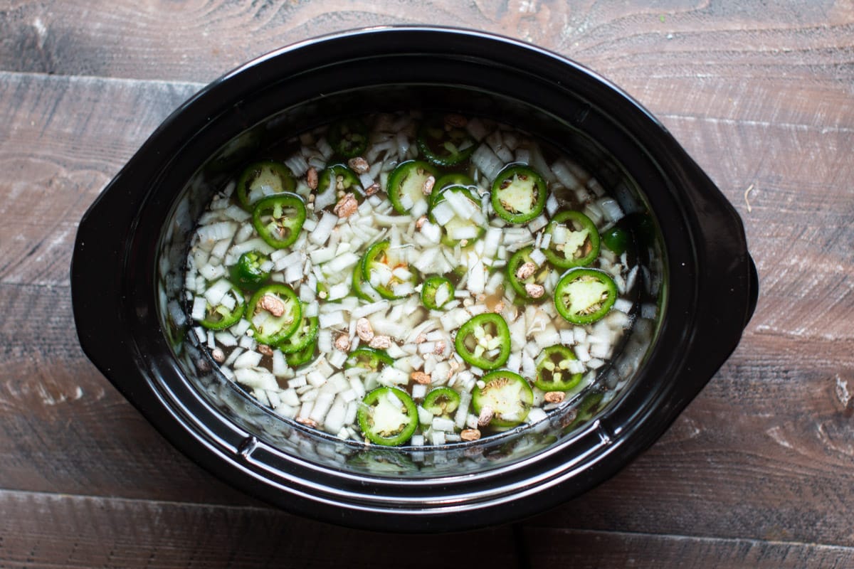 onions, pinto beans and jalapenos in slow cooker