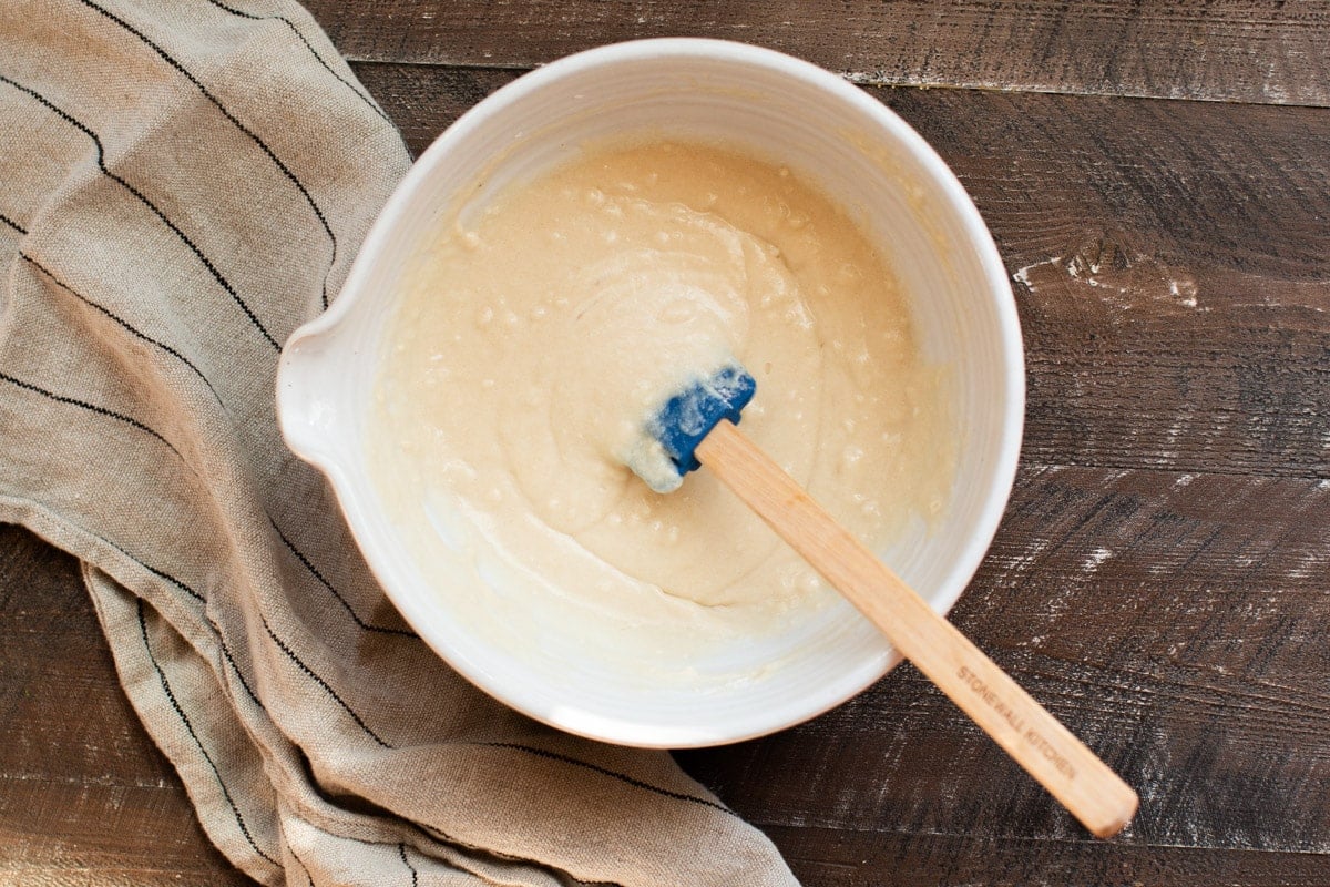 bowl with batter in it. Blue spatula in it.