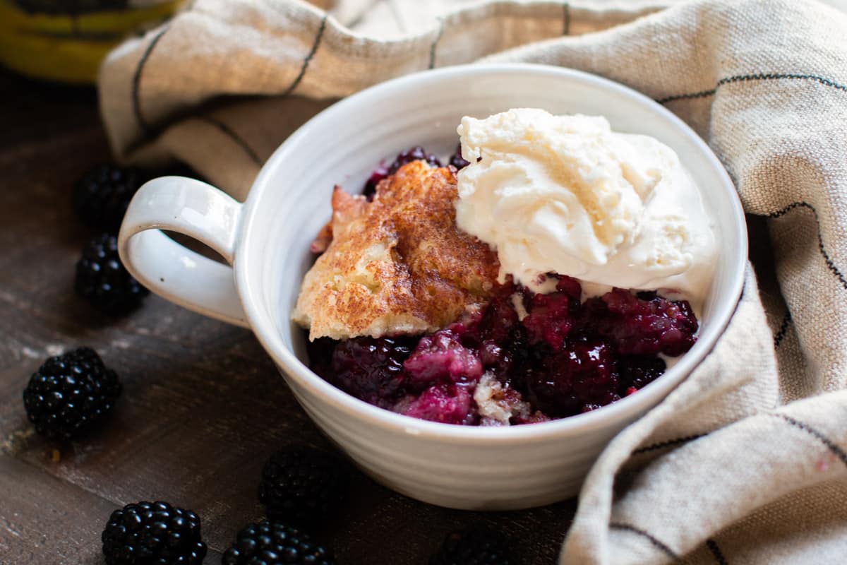 bowl with cobbler and ice cream on top.