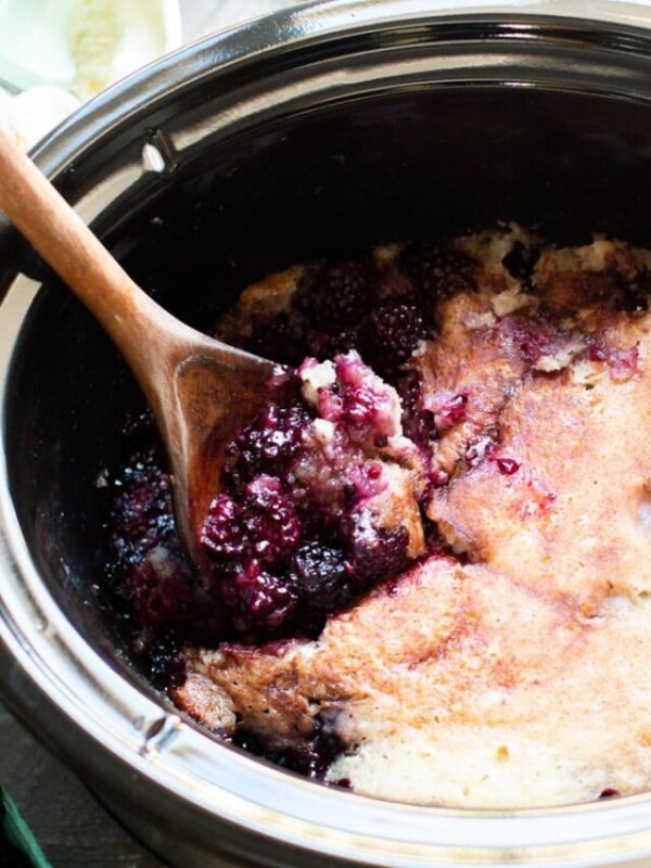 blackberry cobbler with wooden spoon in it.
