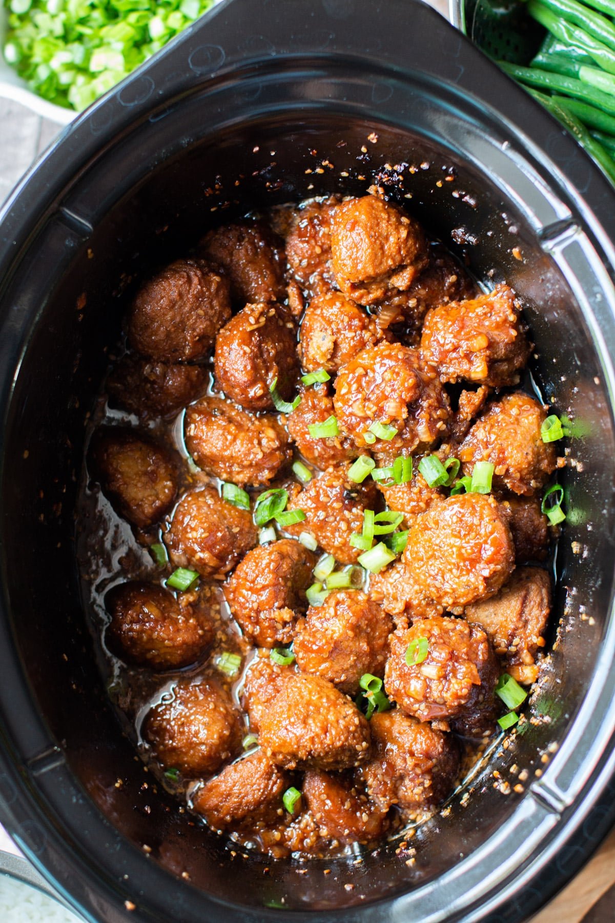 Close up of meatballs in teriyaki sauce in slow cooker