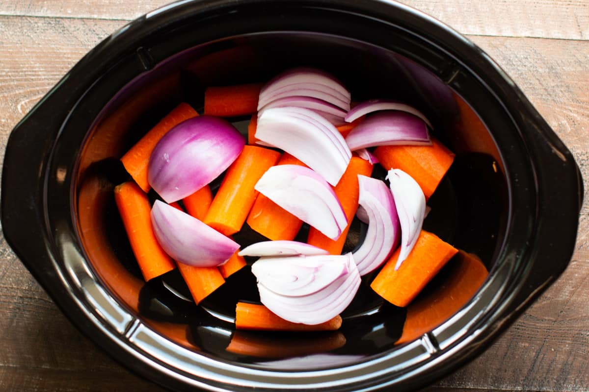 carrots and red onion in a slow cooker