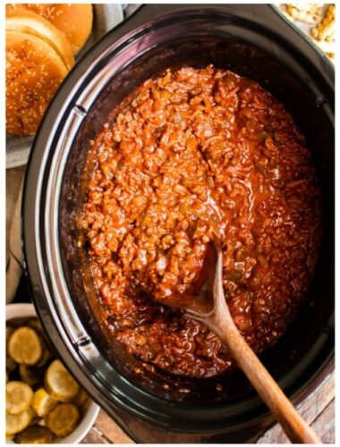 cooked sloppy joe meat in a slow cooker with a spoon in it.