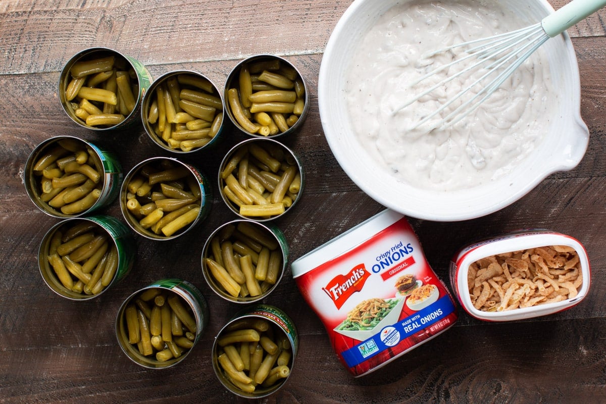 opened green beans, french fried onions, and cream of mushroom mixture on wooden table