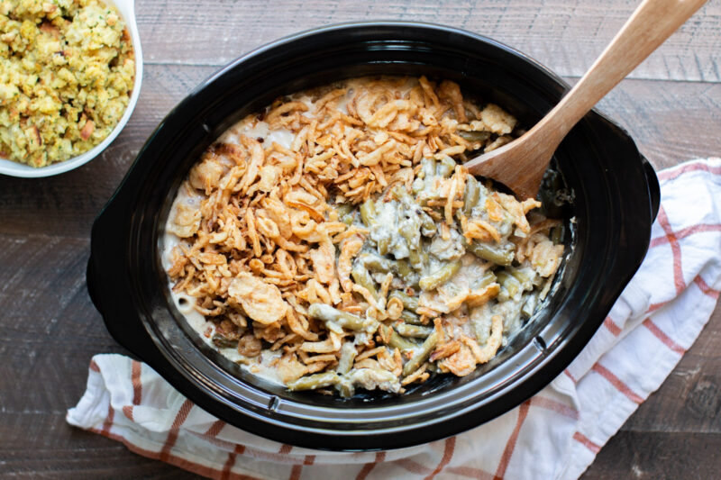 finished cooking green bean casserole with wooden spoon in it