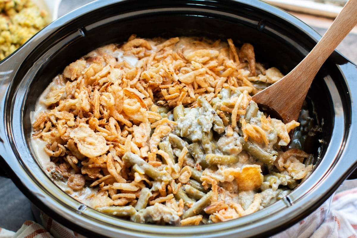 close up image of green beans in sauce with French fried onions on top.