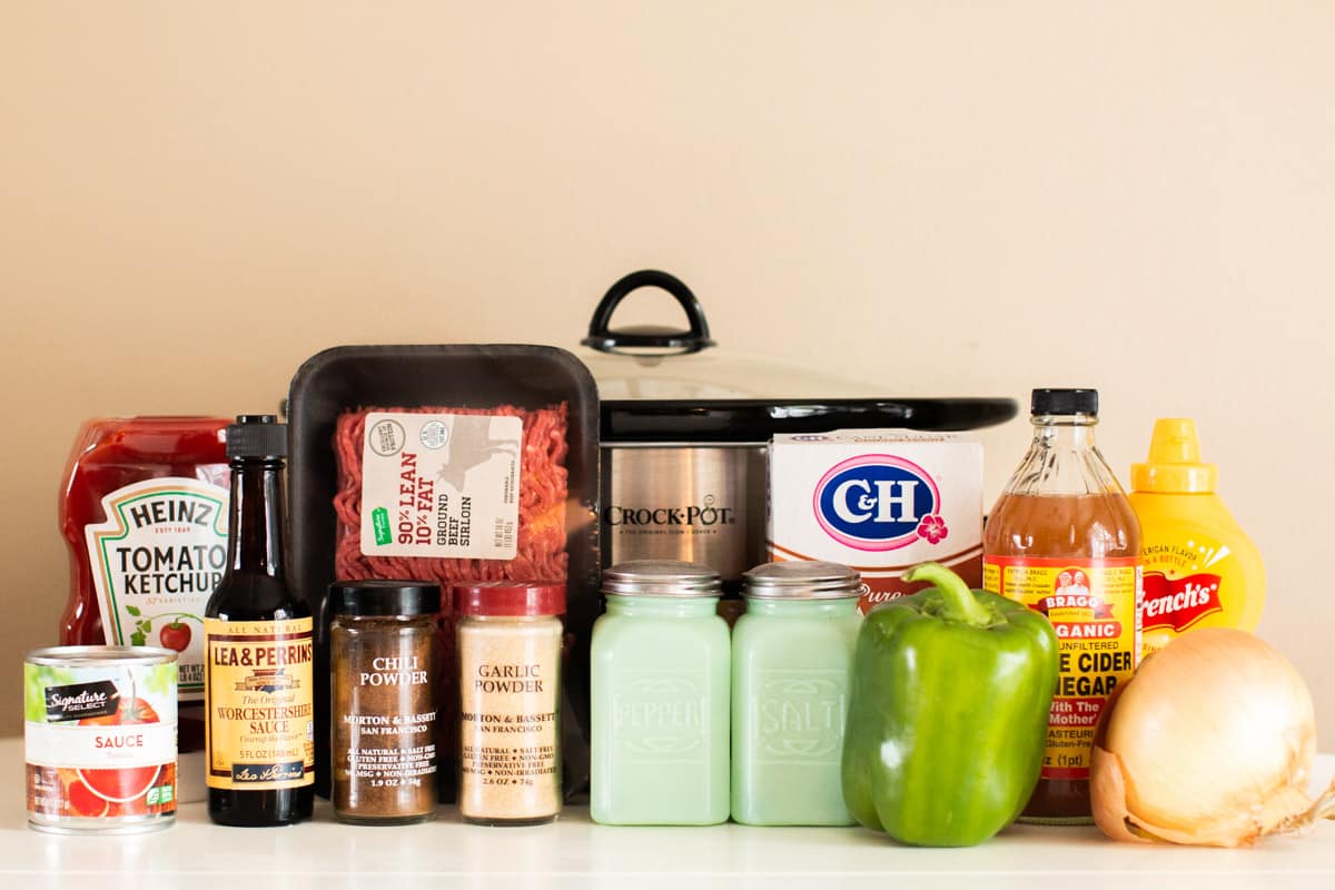 ingredients for sloppy joes lined up in front of slow cooker