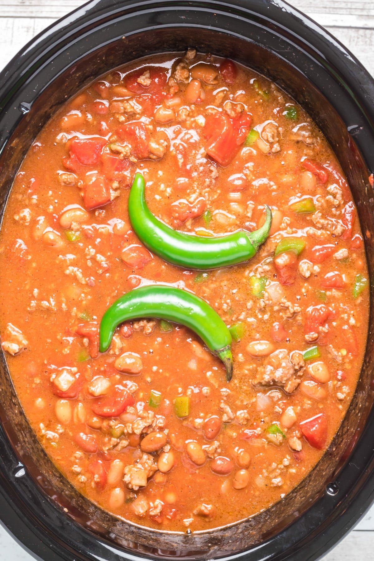 chili with 2 serrano peppers on top