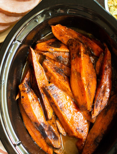 close up of sweet potatoes wedges in a slow cooker